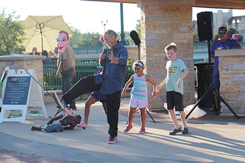 Mask maker Jeff Simmerling performs the Magic of Masks for a crowd Saturday, August 12, 2023 at Venetian Night in Dixon