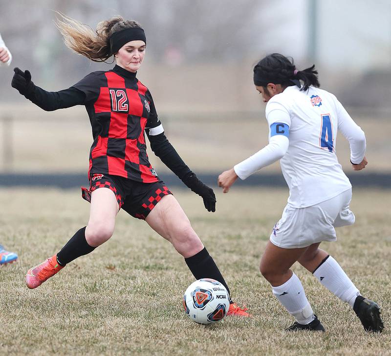 Indian Creek's Emma Turner (left) and Genoa-Kingston's Citlali Serna meet at the ball during their game Thursday, March 16, 2023, at Pack Park Sports Complex in Waterman.