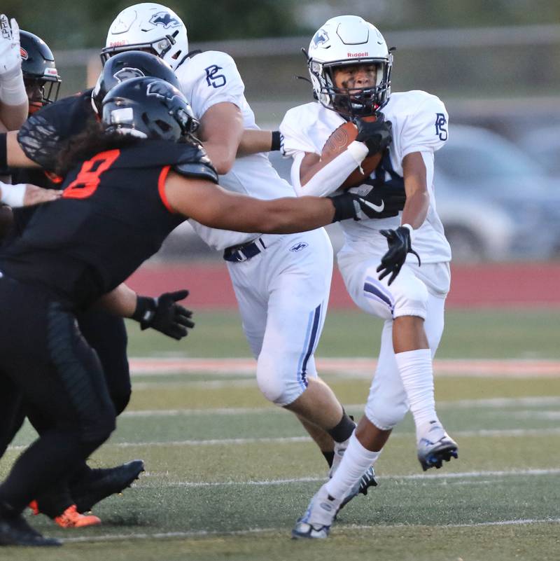Plainfield South's Brooklyn Williams tries to break away from DeKalb's Jeremiah Pineira during their game Friday, Sept. 1, 2023, at DeKalb High School.