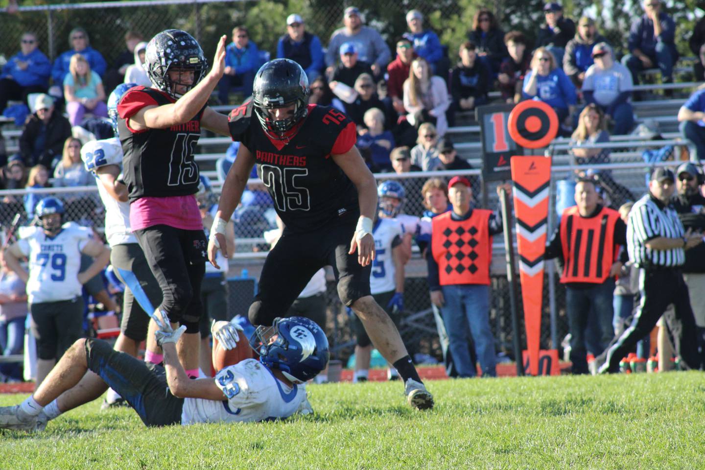 Erie-Prophetstown's Mason Misfeldt (15) congratulates Nick Ballard (75) after tackling Clifton Central running back Jayce Meier (33) for a 5-yard loss in the second half of the Class 2A playoff game at Erie High School.