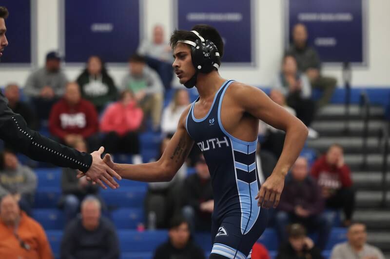 Plainfield South’s Rocco Silva is congratulated by a coach after his win over Plainfield North’s Jaek Curran in a Southwest Prairie dual meet on Wednesday, Nov. 29, 2023 in Plainfield.