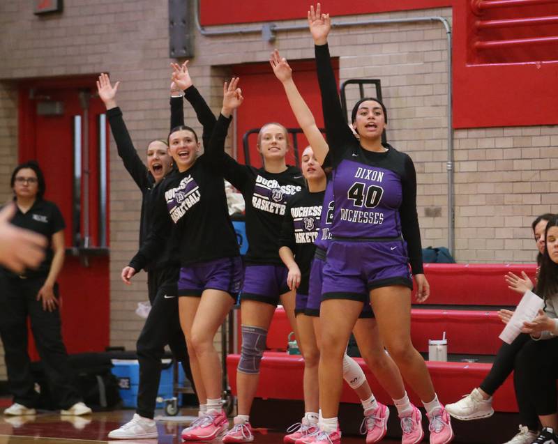 Members of the Dixon girls basketball team react after a teammate sinks a three point basket against Ottawa on Wednesday, Nov. 29, 2023 at Kingman Gym.