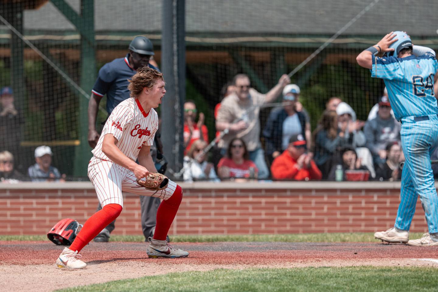 Aurora Christian’s Zach Zappia (26) celebrates tagging out Marquette’s Anthony Couch (24) at home plate at Trout Park in Elgin, IL on Saturday May 31st, 2025.  Both teams competed to take home the 1A Sectional Championship Trophy.  Final Score: Marquette 5, Aurora Christian 1