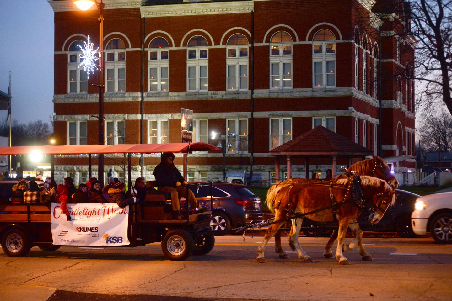 Wagon rides were just part of Oregon's Candlelight Walk on Saturday, Nov. 25. 2023. Here, one of the wagons passes by the historic Ogle County Courthouse.