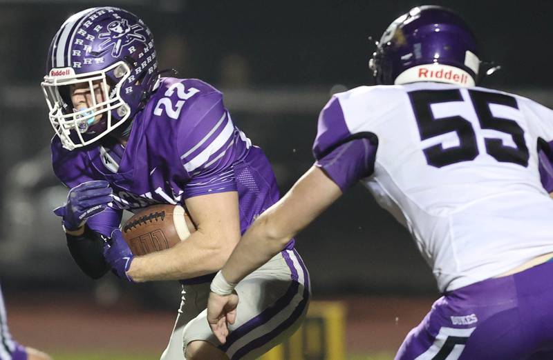 Rochelle's Trey Taft carries the ball as Dixon’s Gavin Jensen closes in during their first round playoff game Friday, Oct. 28, 2022, at Rochelle High School.