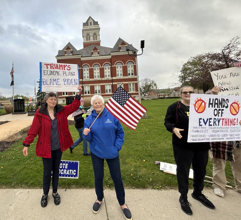 May Day Rally attendees hold signs on Thursday, May 1, 2025 around the historic Ogle County Courthouse in Oregon.
