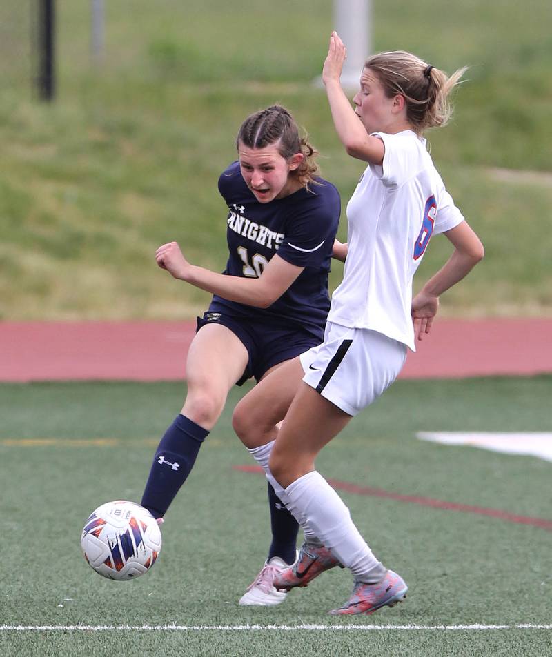 IC Catholic Prep's Ashley Zwolinski kicks the ball away from Pleasant Plains' Caroline Willenborg during the IHSA Class 1A state girls soccer third place game Saturday, May 27, 2023, at North Central College in Naperville.