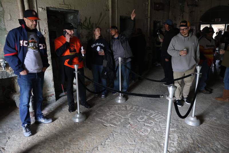 Fans check out the iconic “It’s Never Too Late to Mend” in the deathrow building before the Joliet Slammers preseason game at the Old Joliet Prison on Thursday, April 29, 2026 in Joliet.