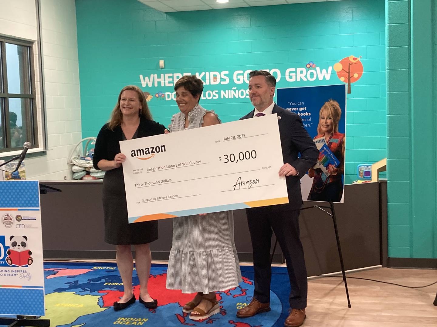 Will County Executive Jennifer Bertino-Tarrant and Will County Center for Economic Development CEO and President Doug Pryor receive a $30,000 donation check from Amazon Head of Community Affairs Sarah Glavin for Imagination Library. 
Monday, July 28, 2025.