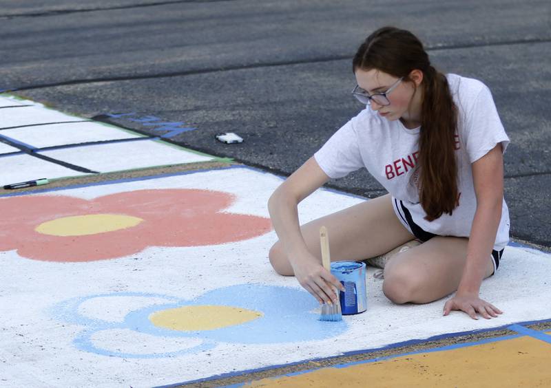 Marian Central Catholic High School senior  Juliette Huff paints a flower on Tuesday, Aug. 13, 2024, while painting her parking spot.