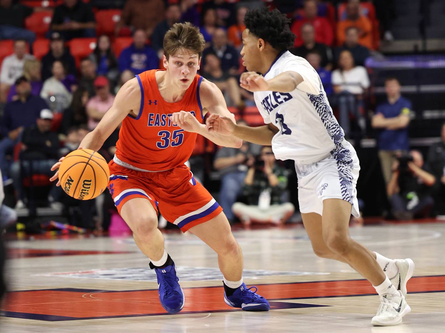 Eastland's Parker Krogman pushes the ball up court against Chicago Hope Academy's Tyjuan Hunter during their IHSA Class 1A state championship game Saturday, March 15, 2025, in the State Farm Center at the University of Illinois in Champaign.