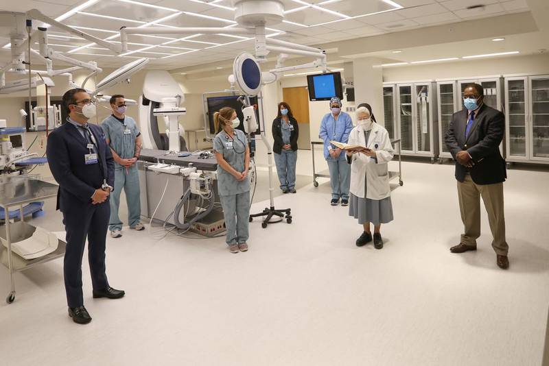 AMITA Health Saint Joseph Medical Center in Joliet recently blessed its new hybrid cardiac catheterization lab. Pictured from left is Dr. Hazem Al Muradi, interventional cardiologist and cath lab medical director; Clarence Shoot, cath lab manager; Jennifer Brill, cardiology nurse; Denise Heimer, cardiology nurse; Sister Josephine Mulcahey, chaplain; and Eric Mangek Ngum, lead chaplain.