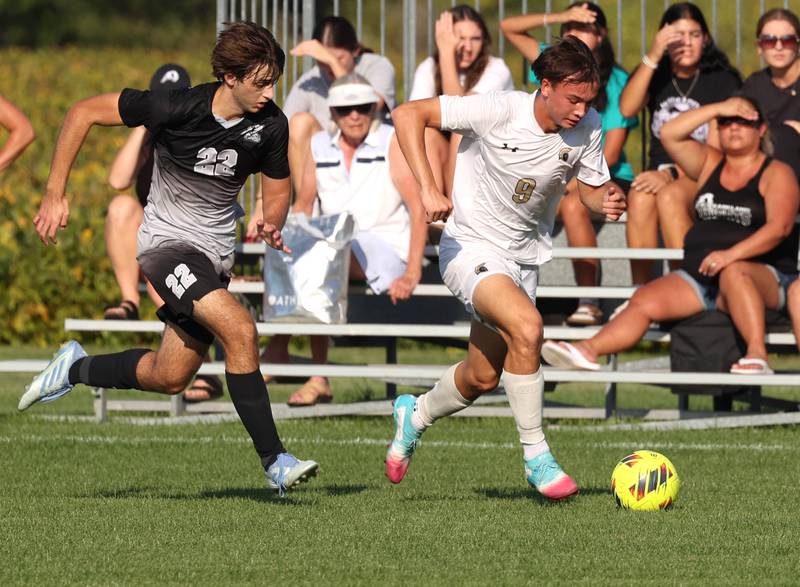 Sycamore's Felix Arends pushes the ball ahead of Kaneland's Carlos Landa as the fans look on during their game Wednesday, Sept. 16, 2025, at Kaneland High School in Maple Park.