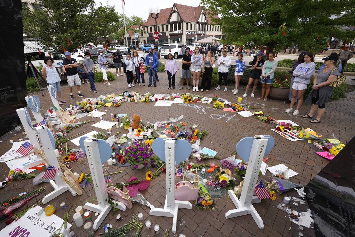 Area residents visit a memorial to the seven people who lost their lives in the Highland Park, Ill., Fourth of July mass shooting, Wednesday, July 6, 2022, in Highland Park. (AP Photo/Charles Rex Arbogast)