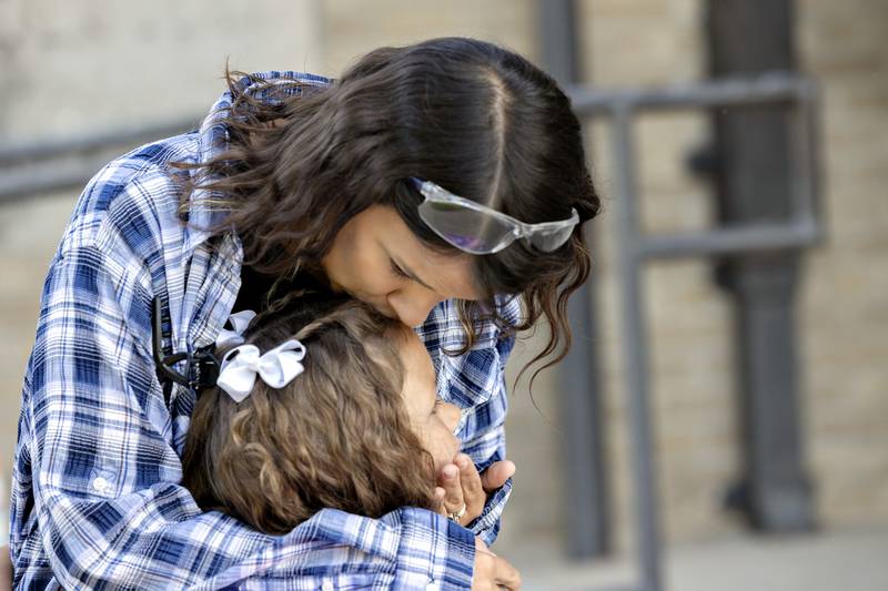 Stephanie Rufus kisses daughter Lainey Vogel, 6, goodbye Wednesday, Aug. 13, 2025, as the first grader goes into Washington for the first day of the Dixon school year.