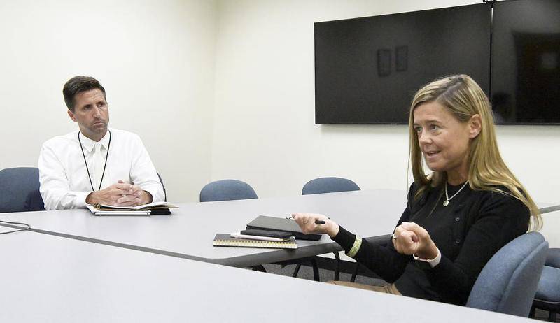 Jassen Strokosch (left), Deputy Director of Communications for the Department of Children and Family Services, listens to Tierney Stutz, Division of Child Protection Deputy Director, on Wednesday, Aug. 21, 2019, at DCFS' Joliet office.