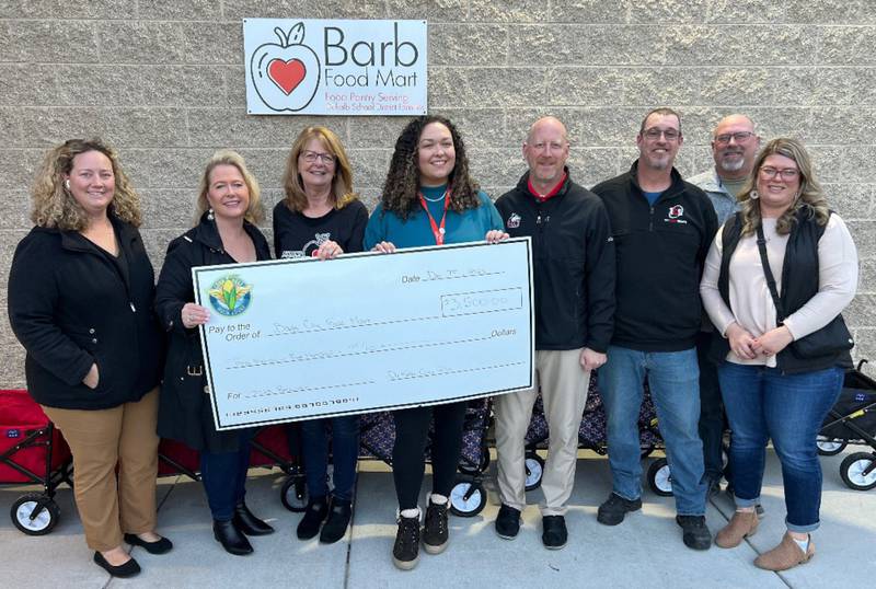 The Corn Fest board recently presented a $3,500 check to Barb Food Mart. Pictured from left are Christi Coulter, Lisa Angel, Nancy Partch, Denise Salihoglu, Shawn Lowe, Brian Reynolds, Sean Larson and Jessica Dewey.