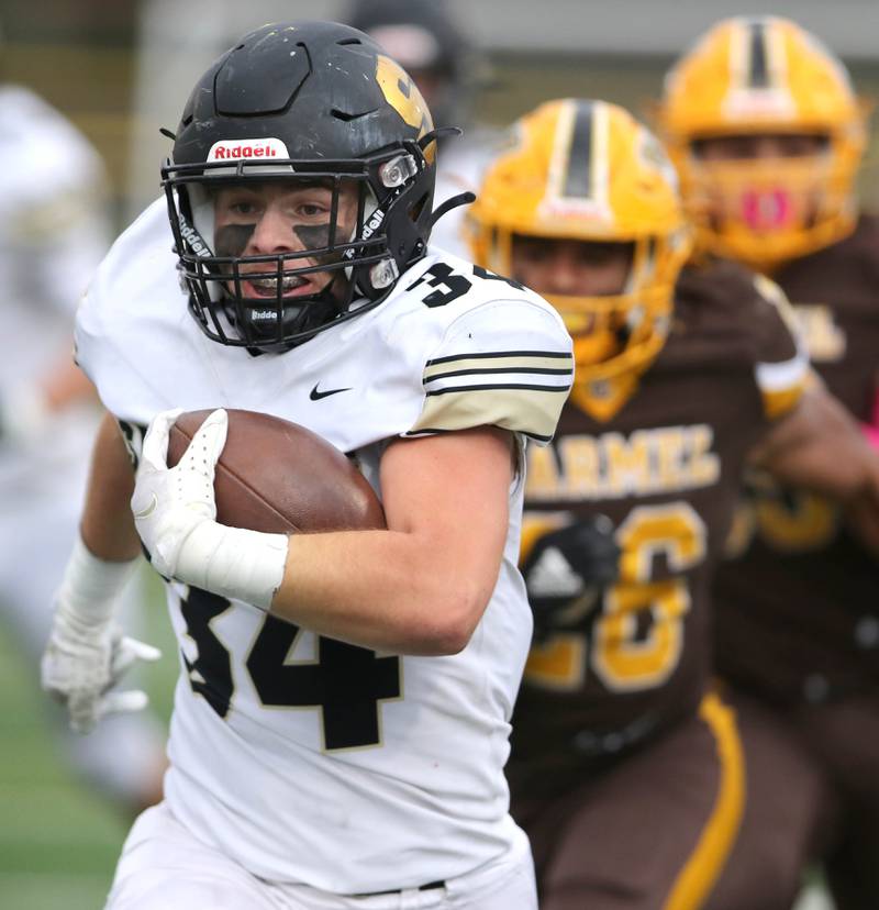 Sycamore's Joey Puleo scores on a long touchdown run during their Class 5A second round playoff game against Carmel Saturday, Nov. 5, 2022, at Carmel Catholic High School in Mundelein.