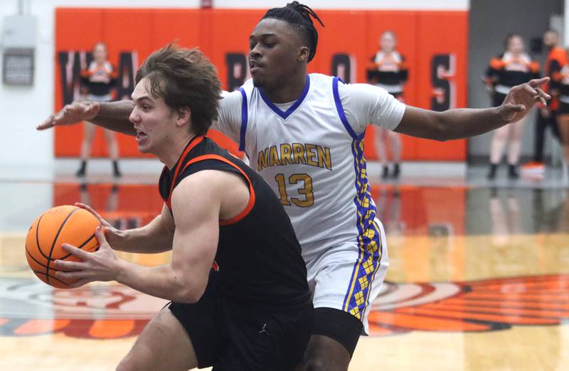 Warren’s Javerion Banks, back, guards McHenry’s Kyle Maness in IHSA Class 4A Regional Title Game boys basketball action on Friday, Feb. 28, 2025 at McHenry High School in McHenry.