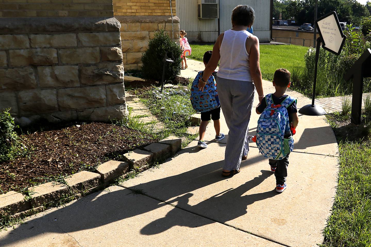 Landmark Principal Margaret Carey walk students to the meeting area before the first day of school for McHenry's Landmark Elementary School on Wednesday, July 17, 2024.