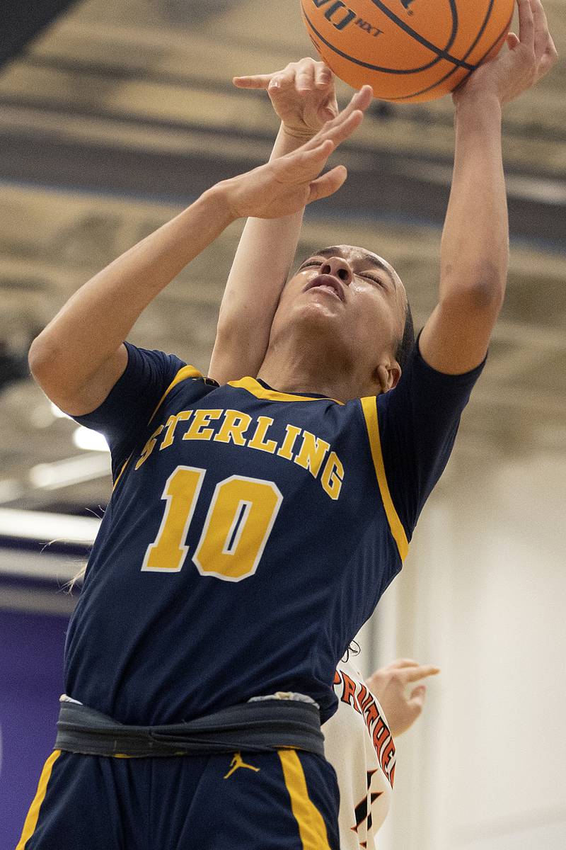 Sterling’s Nia Harris is fouled by Washington’s Ainsley Redlingshafer Monday, March 3, 2025, during the 3A Supersectional at Rochelle High School.