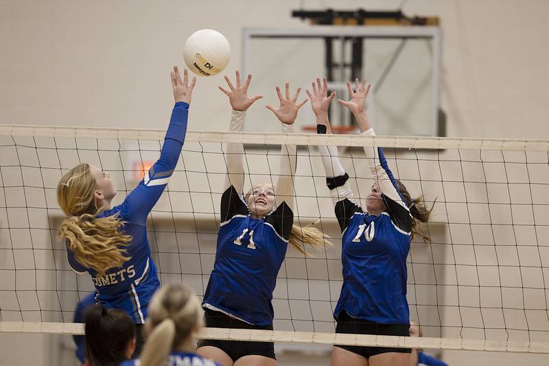 Newark’s Bre Dixon (left) and Kodi Rizzo go up for a block in the semifinal sectional game Monday, Oct. 31, 2022 against Newman.