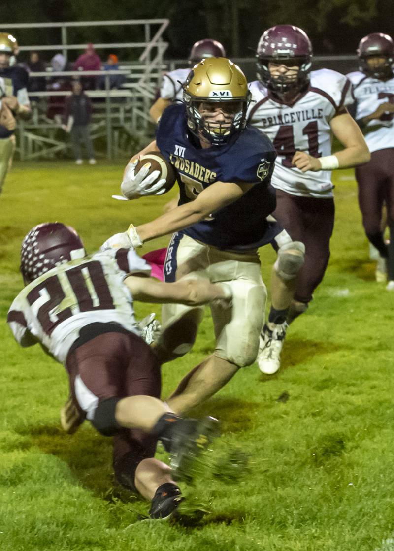 Marquette's Tom Durdan (5) shakes off a tackle try by Princeville's Grant Hunt in Friday's 1A playoff game in Ottawa.