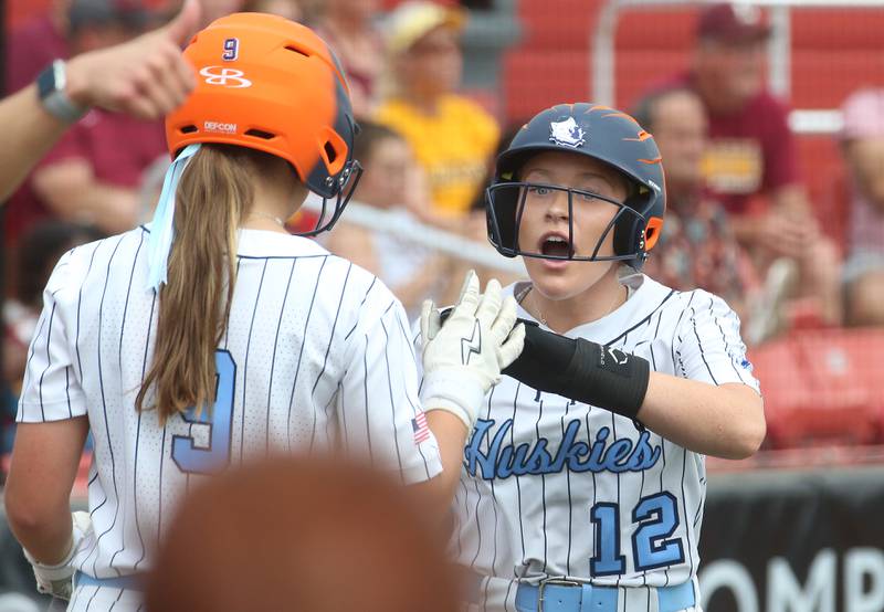 Oak Park River Forest's Maura Carmody hi-fives teammate Julia Henderson after scoring a run against Lockport during the Class 4A third-place game on Saturday, June 14, 2025 at the Louisville Slugger Sports Complex in Peoria.