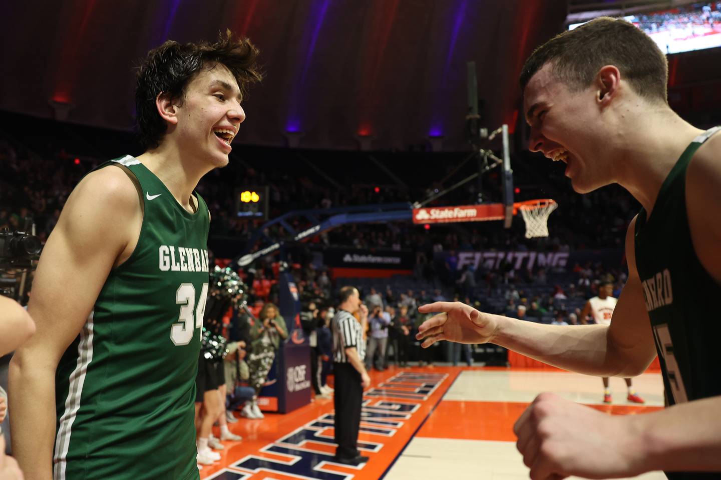 Glenbard West’s Braden Huff (34) and Ryan Renfro celebrate the final seconds of their 56-34 win over Whitney Young in the Class 4A championship game at State Farm Center in Champaign. Saturday, Mar. 12, 2022, in Champaign.
