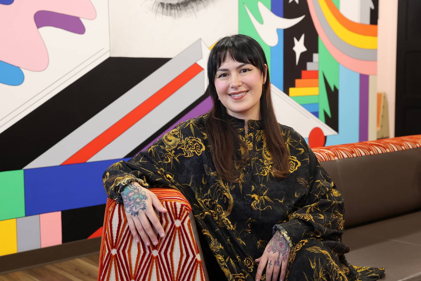 Electric Lady Lounge owner Bri Haug poses for a photo in her tattoo studio in Bradley.