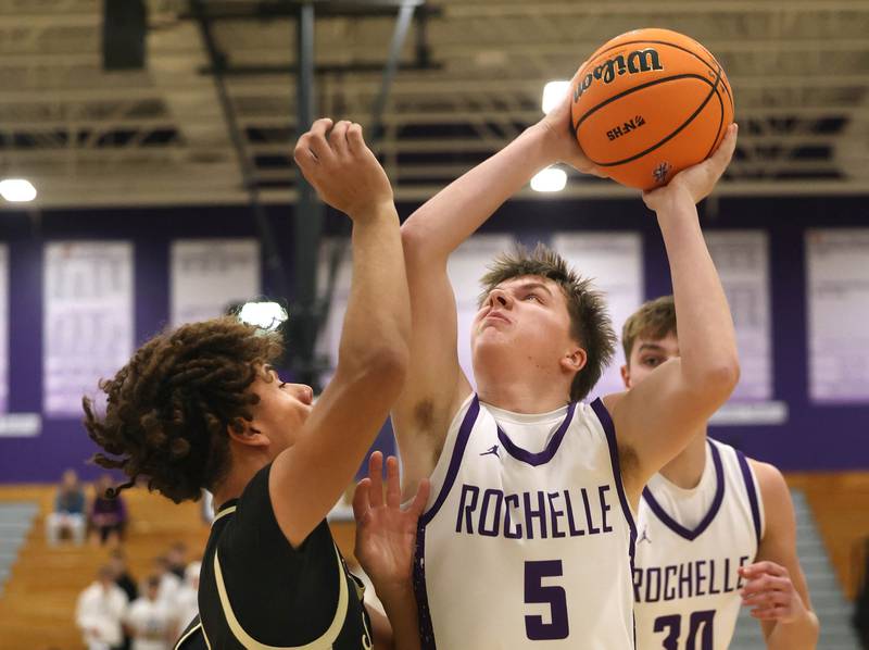 Rochelle's Mason Ludwig shoots over Sycamore's Josiah Mitchell Friday, Dec. 5, 2025, during their game at Rochelle High School.