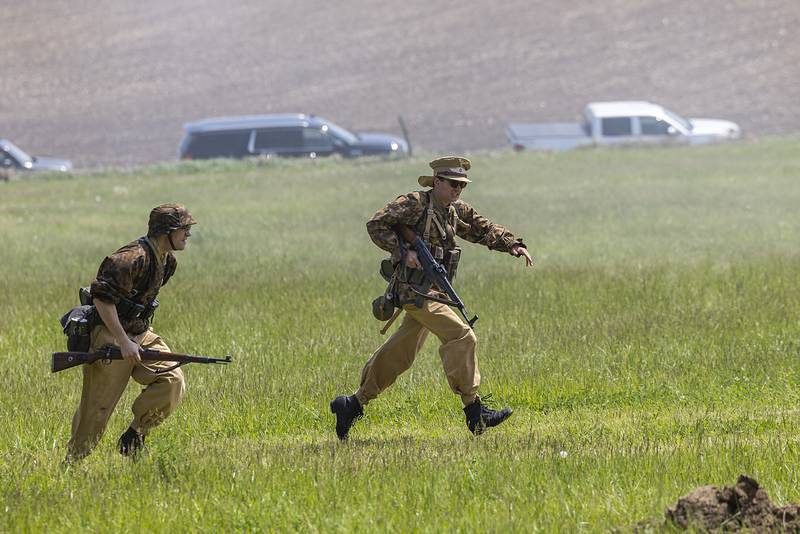 Axis troops move into position Saturday, May 16, 2026,  during a reenactment of the Battle of Anzio in Franklin Grove.