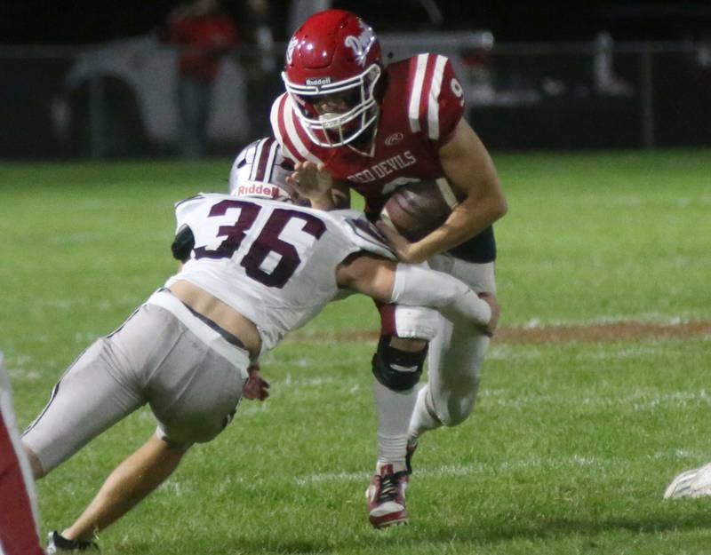 Hall quarterback Gianni Guerrini runs the ball while Illinois Valley Central's Connor Buchanan bring him down on Friday, Sept. 29, 2023 at Richard Nesti Stadium.