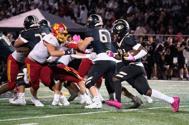 Glenbard North's Elliston Damarion (14) carries the ball against Batavia during a football game at Glenbard North High School in Carol Stream on Friday, Sep 23, 2022.