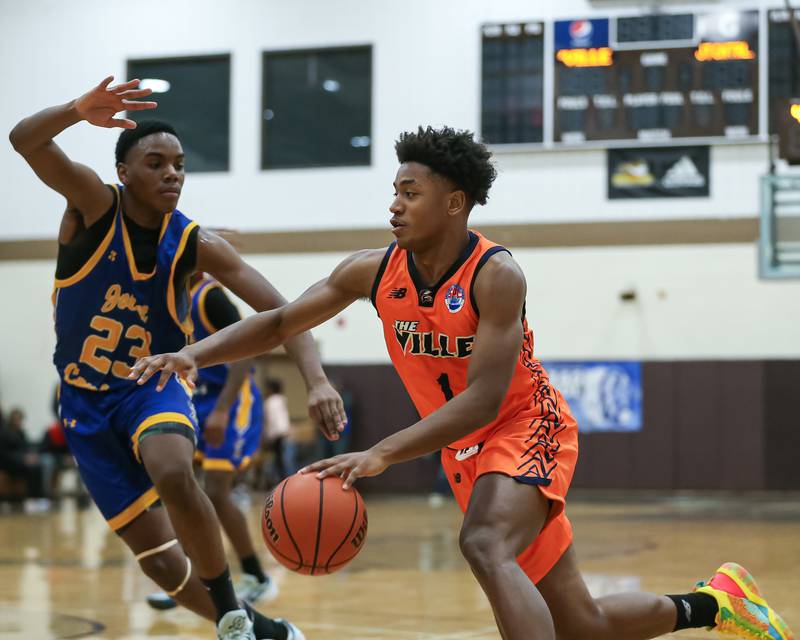 Romeoville's Mickeis Johnson (1) drives baseline against Joliet Central's Danny Thompson (23) in the WJOL Tournament Championship game. Nov 25, 2023.