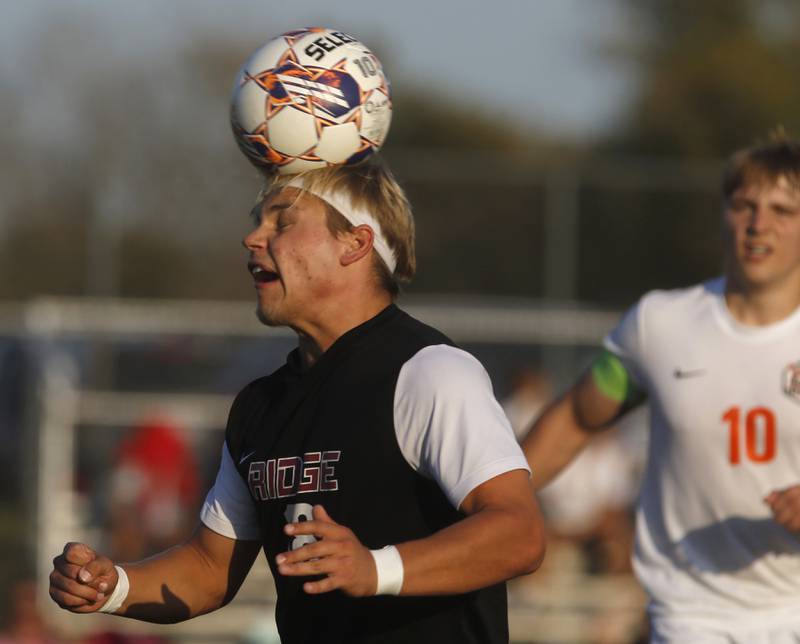 Prairie Ridge's Gabriel Porter heads the ball in front of Crystal Lake Central's Gideon Burleson during a Fox Valley Conference soccer match on Thursday, Oct. 10, 2024, at Prairie Ridge High School.