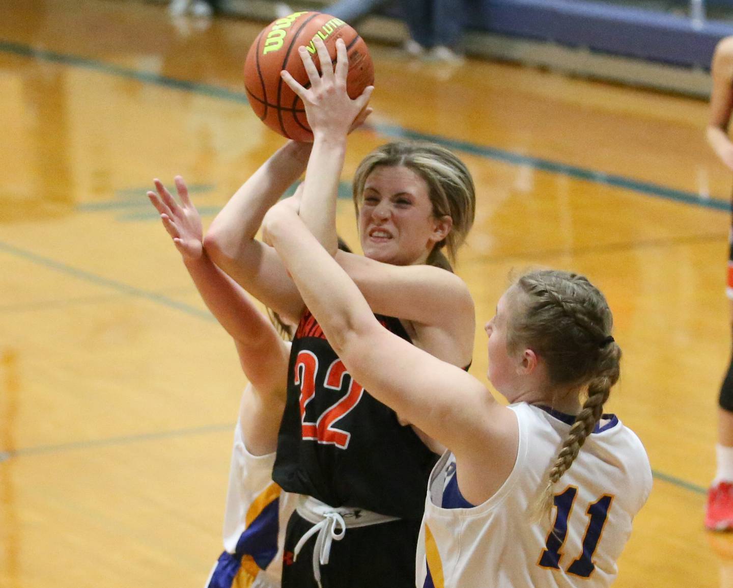 Sandwich's Kaylin Herren (22) fights her way into the lane where she is met by Somonauk's Morgan Potter (11) in the Tim Humes Breakout Tournament on Friday, Nov. 18, 2022 in Somonauk.