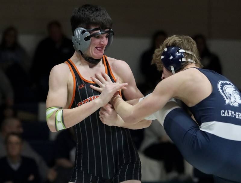 Crystal Lake Central’s Nick Zuehlke, left, battles Cary-Grove’s Tanner Hurley at 150 pounds in varsity wrestling Thursday, Dec. 19, 2024 at Cary-Grove High School in Cary.