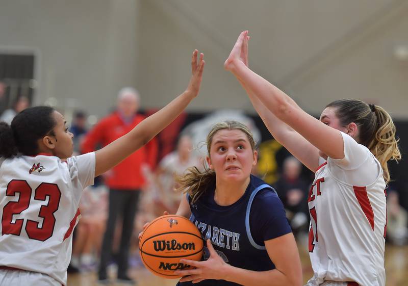 Nazareth’s Stella Sakalas drives between Benet’s Chloe Vicens (23) and Lucy Tierney during a game on January 28, 2026 at Benet Academy in Lisle.