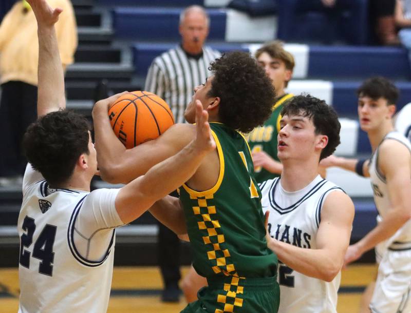 Cary-Grove’s Brady Bauer, left, and Adam Bauer, right, guard  Crystal Lake South’s Noah Cook in varsity boys basketball on Wednesday, Dec. 3, 2025, at Cary-Grove High School in Cary.