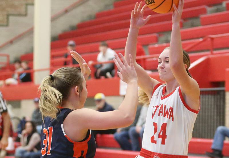 Ottawa's Ashlynn Ganiere passes the ball over the head of Pontiac's Bailee Branscum during the Ottawa Girls Holiday Tournament on Monday, Dec. 16, 2024 in Kingman Gym at Ottawa High School.