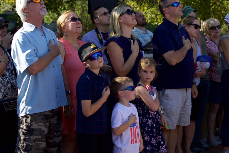 Patriot's salute the flag as it is raised at the Flag Day Monument opening ceremony's at Patriot's Park on Sunday, Oct 1,2023 in Batavia.