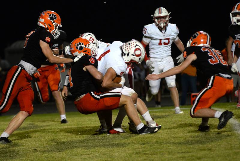 Oregon's Jackobi Donagen is stopped by Byron defenders on Friday, Sept. 12, 2025 at Everett Stine Stadium in Byron.