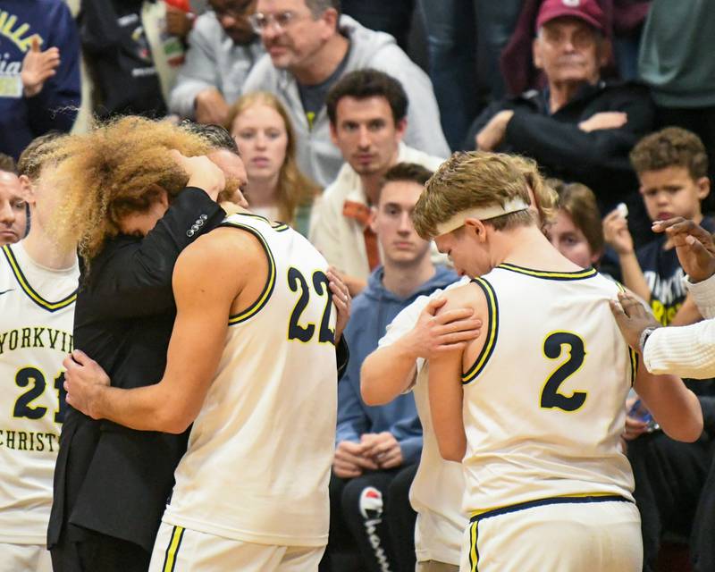 Yorkville Christian teammates Noah Aguado (22) and Brady Sovern (2) get comforted as the clock runs out during the regional title game as their season comes to close as they took on Aurora Christian on Friday Feb. 28, 2025, held at Indian Creek High School.