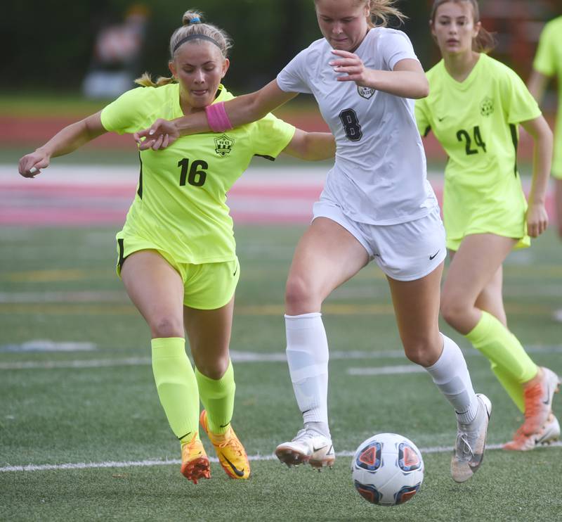 Richmond-Burton's Lexie Anderson (16) chases down a loose ball with Quincy Notre Dame's Sophie Gramke during Saturday’s IHSA Class 1A state girls soccer championship game at North Central College in Naperville.