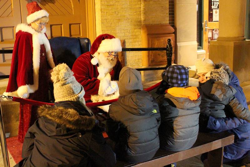 Santa and Mrs. Claus meet with children during the annual Lighting of the Square event on Friday, Nov. 26, 2021, in Woodstock.