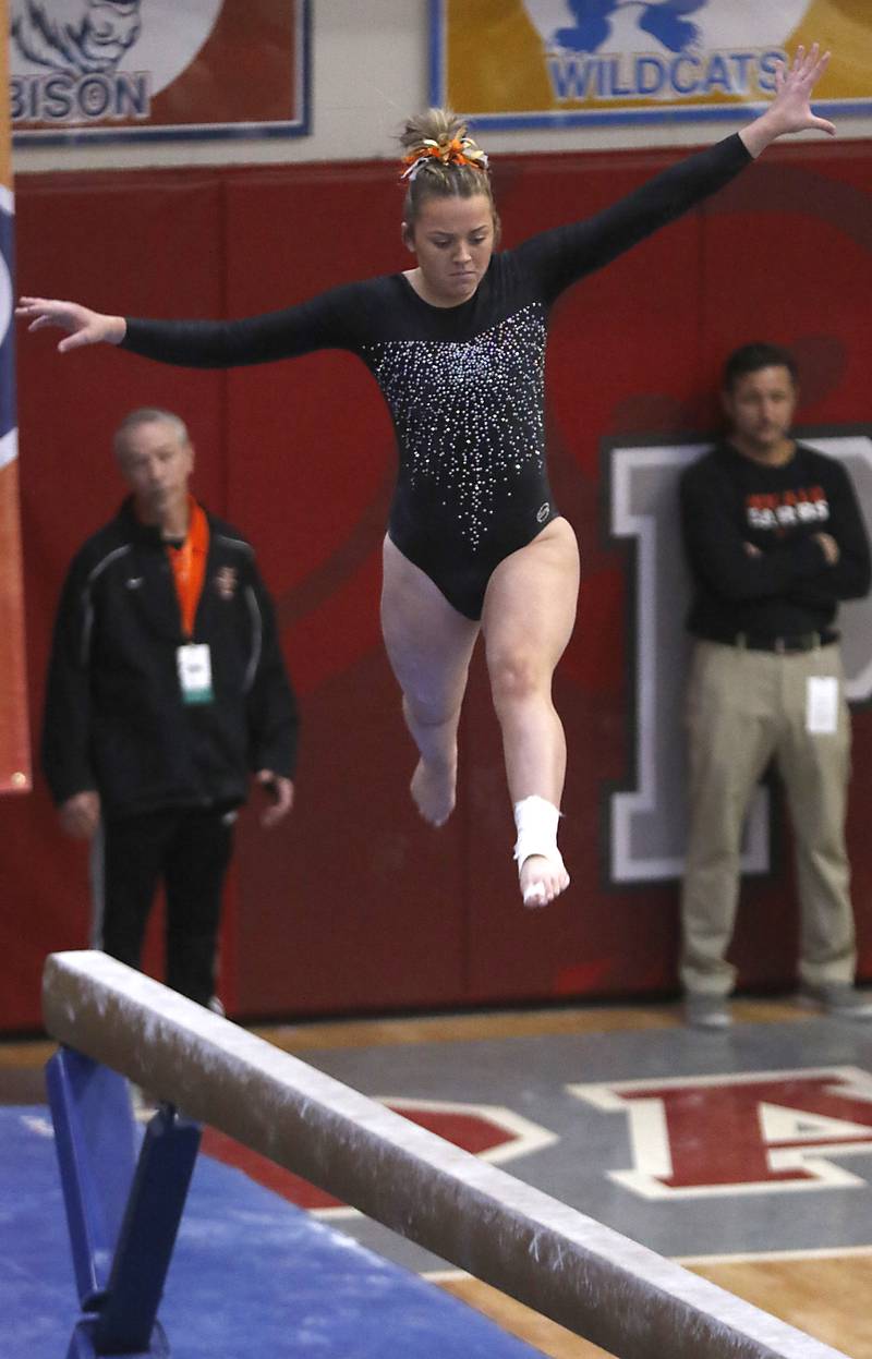 Prairie Ridge’s Gabby Riley competes in the of the uneven parallel bars Friday, Feb. 17, 2023, during the IHSA Girls State Final Gymnastics Meet at Palatine High School.