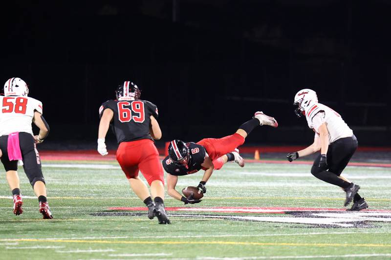 Lincoln-Way Central's Aiden Hennings dives to secure an interception during the Knight's 28-20 victory over Bradley-Bourbonnais on Friday, Oct. 3, 2025.
