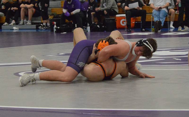 Rochelle's Benjamin Morris (in purple) gets the upper hand in his match during a dual meet with Morris and Sandwich on January 8.