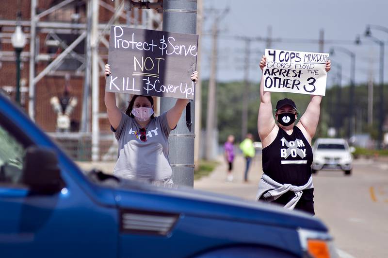 Protesters stand at the corner of River Street and Galena in Dixon Monday holding signs against the killing of George Floyd by a Minneapolis police officer. The video set off a wave of protests and violence world wide.